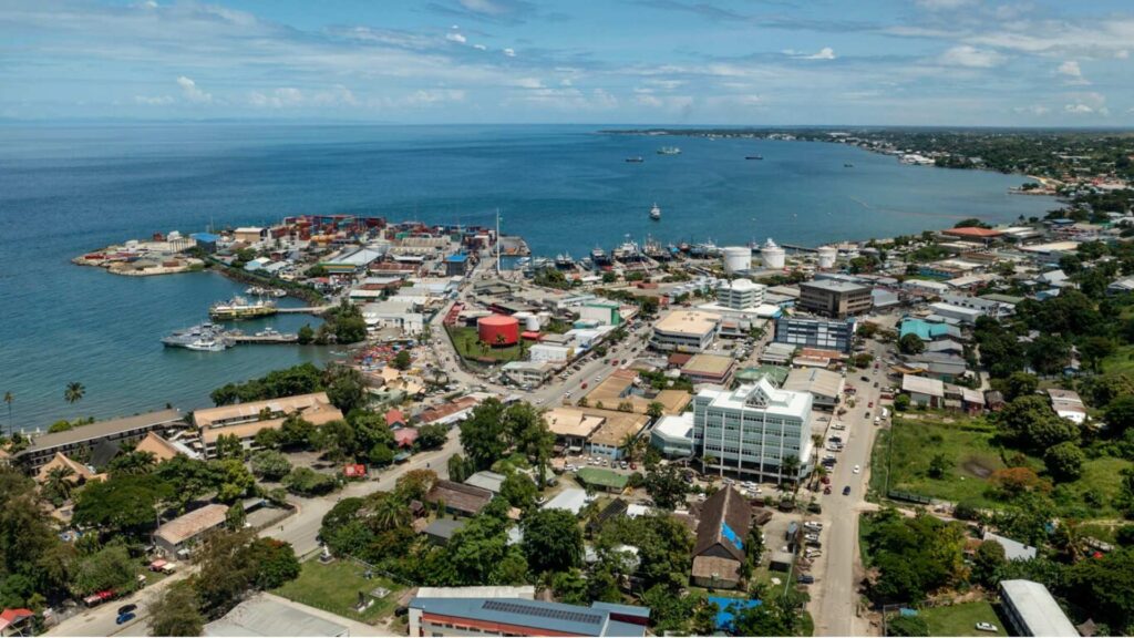 solomon islands Honiara - solomon islands flag Aerial view of Honiara, the capital of the Solomon Islands, with waterfront buildings and the harbor.
