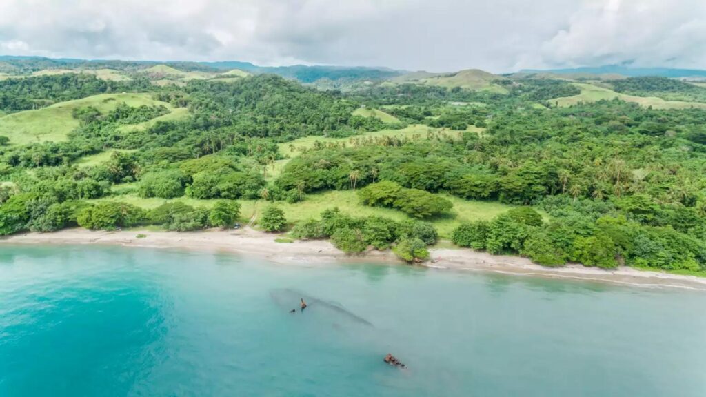 solomon islands Lake Tegano - solomon islands flag Aerial view of Lake Tegano and coastal cliffs on Rennell and Bellona, UNESCO World Heritage sites in the Solomon Islands.