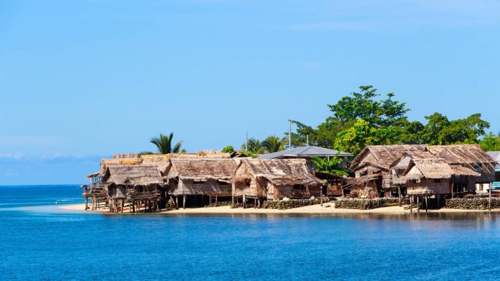 solomon islands Malaita Province - solomon islands flag Traditional stilt houses along the coast of Malaita, one of the most populated islands in the Solomon Islands.
