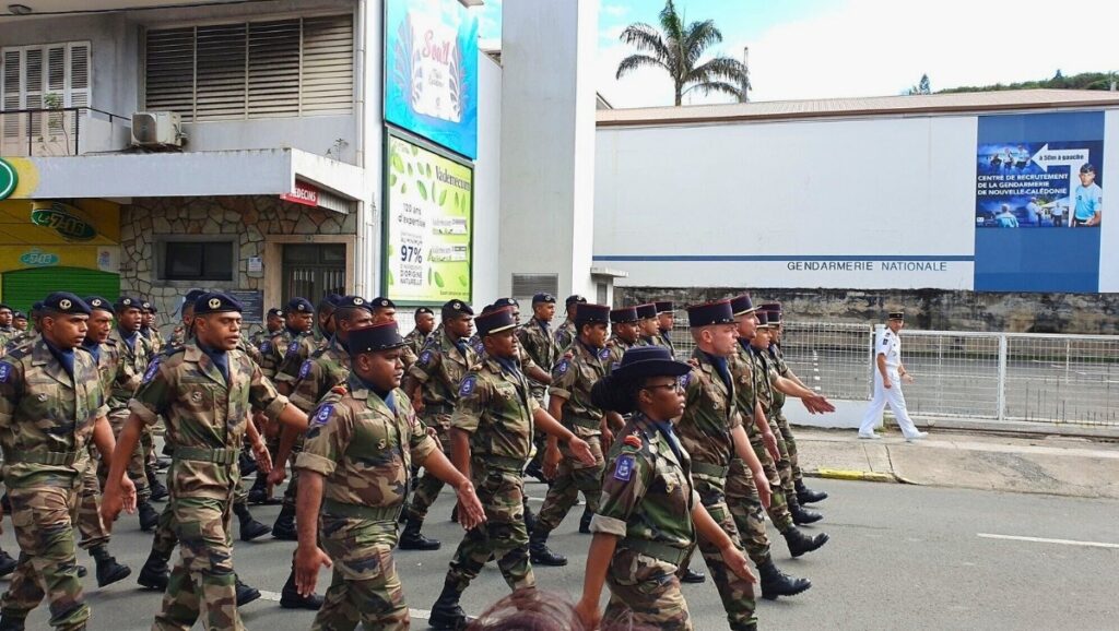 French soldiers parade through Nouméa, New Caledonia, during Bastille Day celebrations, honoring France’s national holiday with local participation.