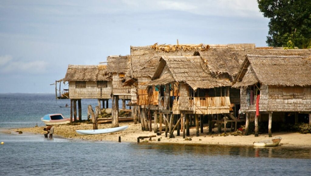 Traditional stilt houses along the Solomon Islands coast, symbolizing the close-knit Wantok system
