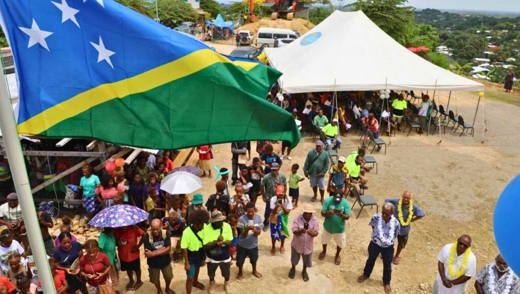 Community celebrating Solomon Islands Independence Day with the national flag flying high.