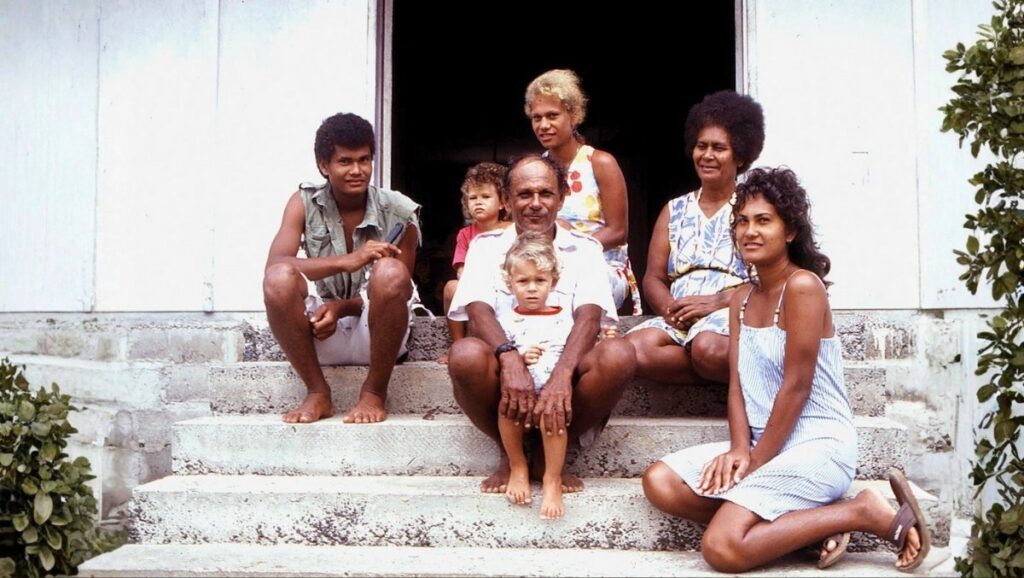 A multigenerational Solomon Islands family gathered at home, symbolizing Melanesian unity, love, and culture