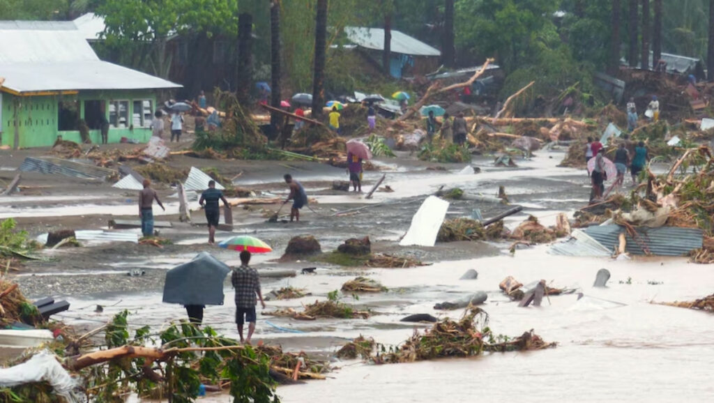 Residents of a Solomon Islands village clearing flood debris after a severe storm.