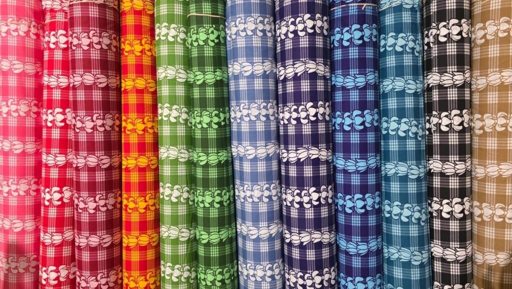 65 Polyester 35 Cotton Palaka Rolls of multicolored Palaka fabric arranged side by side