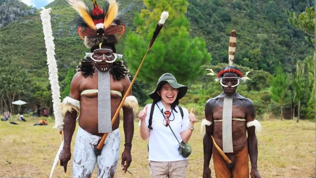 Baliem Valley Festival - papua koteka Visitors and tribesmen in traditional attire at the Baliem Valley Festival in Papua, celebrating indigenous culture, heritage, and community pride.