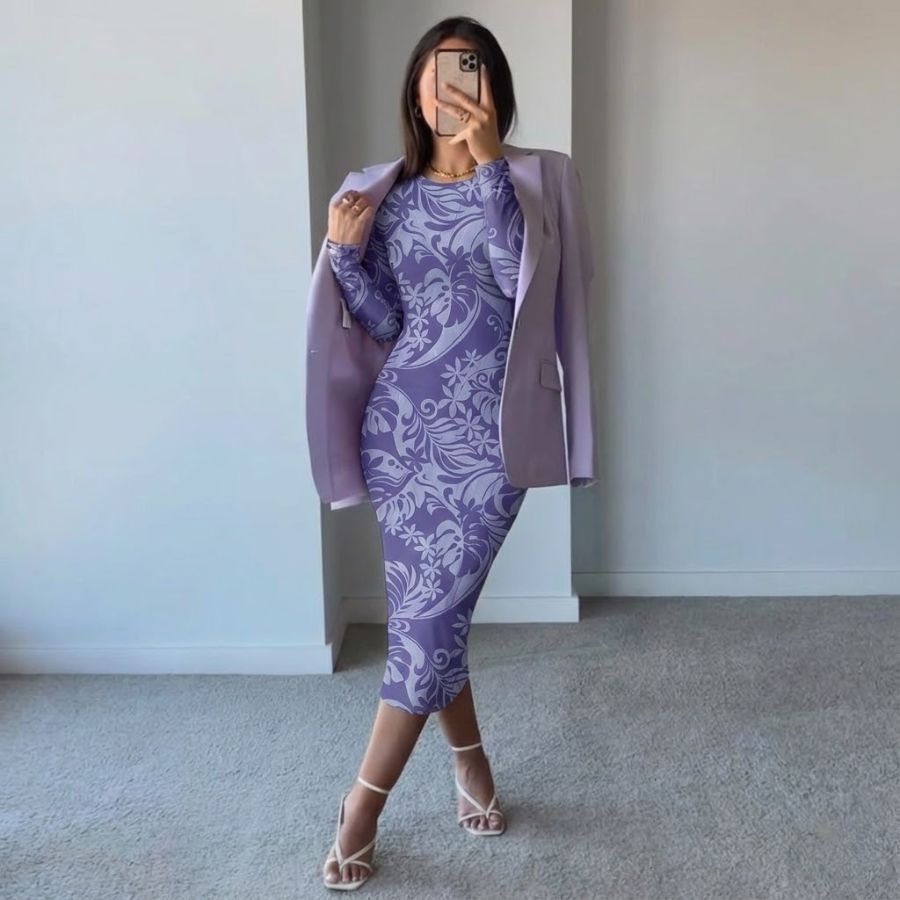 Woman wearing purple long sleeve floral bodycon midi dress with matching blazer and heels, posing in minimalist room