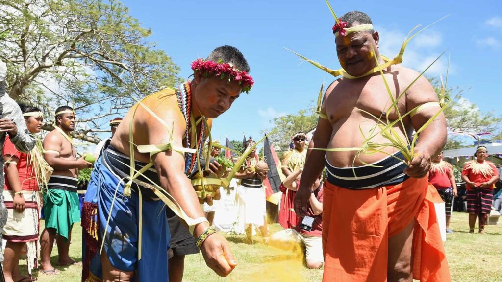 Two Chamorro men performing a traditional ceremony in Guam