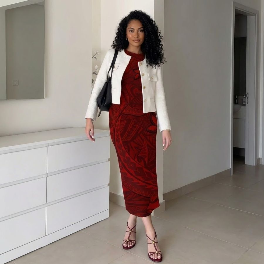 Polynesian woman wearing red patterned bodycon midi dress with cream cropped jacket and strappy heels, standing in minimalist bedroom