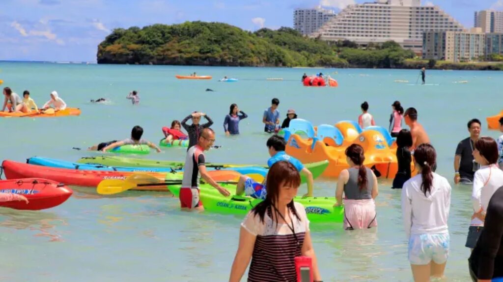 Visitors relaxing on a beach in Guam